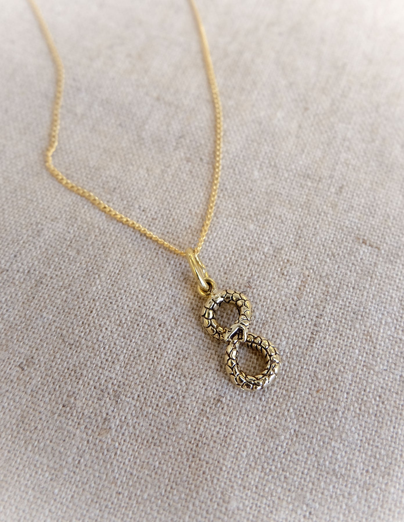 Ouroboros Infinity Charm in Brass